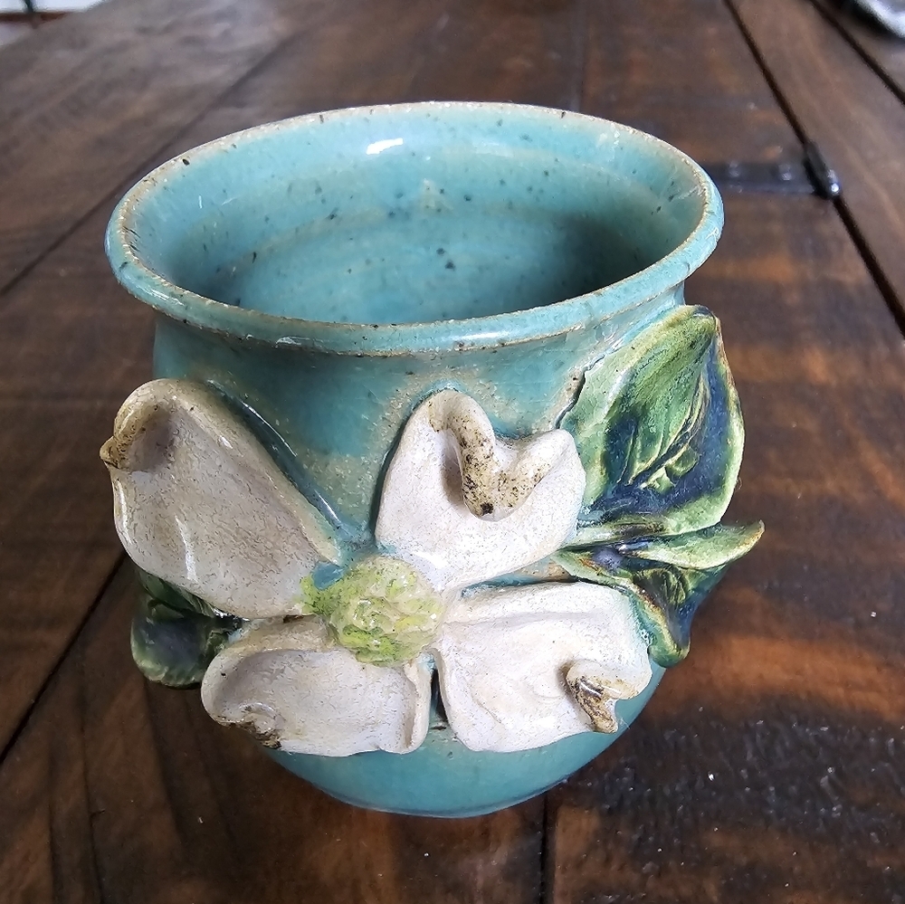Gorgeous Teal pottery vase with dogwood bloom.